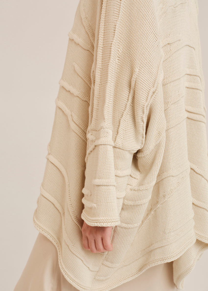 Beige textured garment on a neutral background