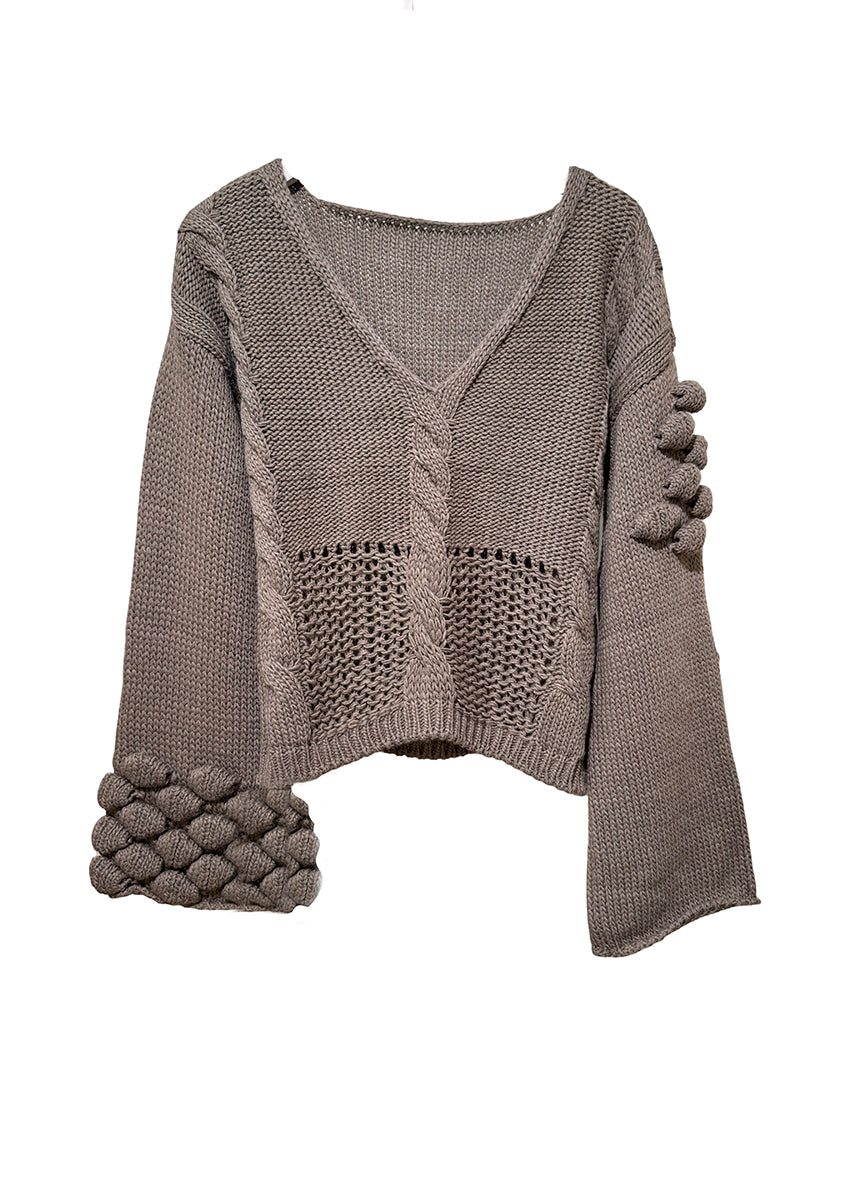 Mocha knitted sweater with textured sleeves on a white background