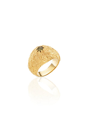 Gold ring with textured design on a white background