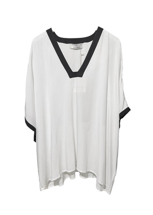 White blouse with black accents on a white background