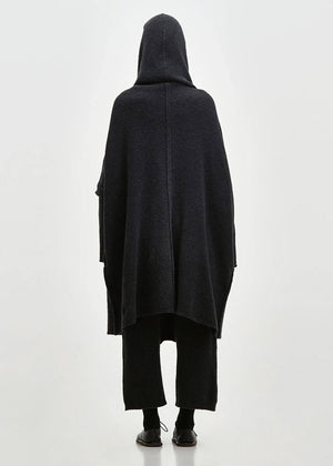 Person wearing a black cardigan on a white background