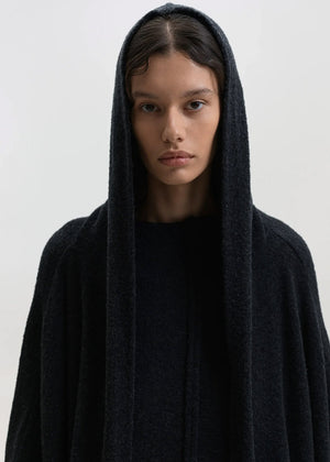 Person wearing a black cardigan on a white background