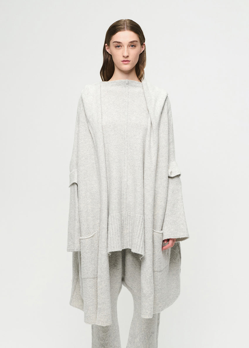 Woman wearing a light gray outfit on a white background