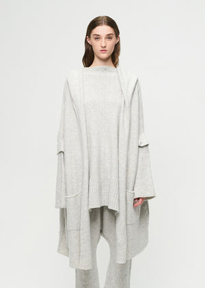 Woman wearing a light gray outfit on a white background