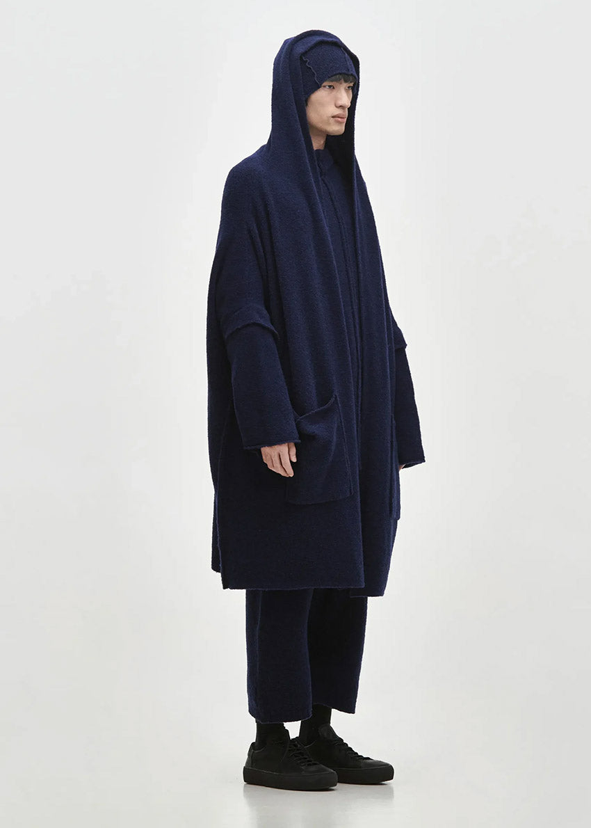 Person wearing a midnight blue cardigan on a white background