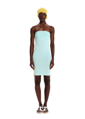 A woman wearing a turquoise strapless dress with a yellow headscarf.