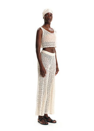 Woman wearing a white lace outfit on a white background