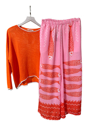 Orange long-sleeve shirt and pink pants with fish pattern on a white background