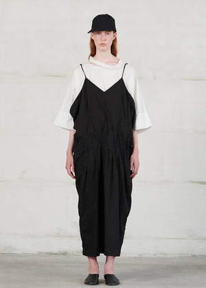 Long dress with thin straps, cut for a relaxed fit, made of soft cotton poplin. CASO features a V neck both in the front and back, open low armholes creating draping on the sides, and decorative nervirs on the front side.