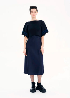 Knit short – sleeved crop top made of 100% Greek cotton in a loose fit. It features a design with details of stripes.