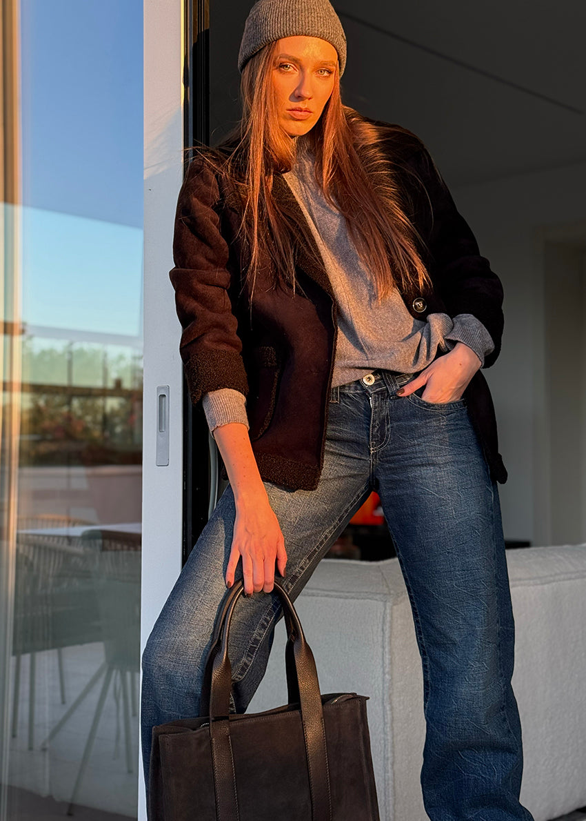 Black shearling short coat. Featuring a plush faux-shearling lining, cozy collar, and practical front pockets.