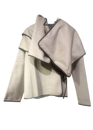 Short wrap beige coat made of furry wool that ties at the side and has a detachable scarf.A winter must – have coat that can be worn from morning to night.
