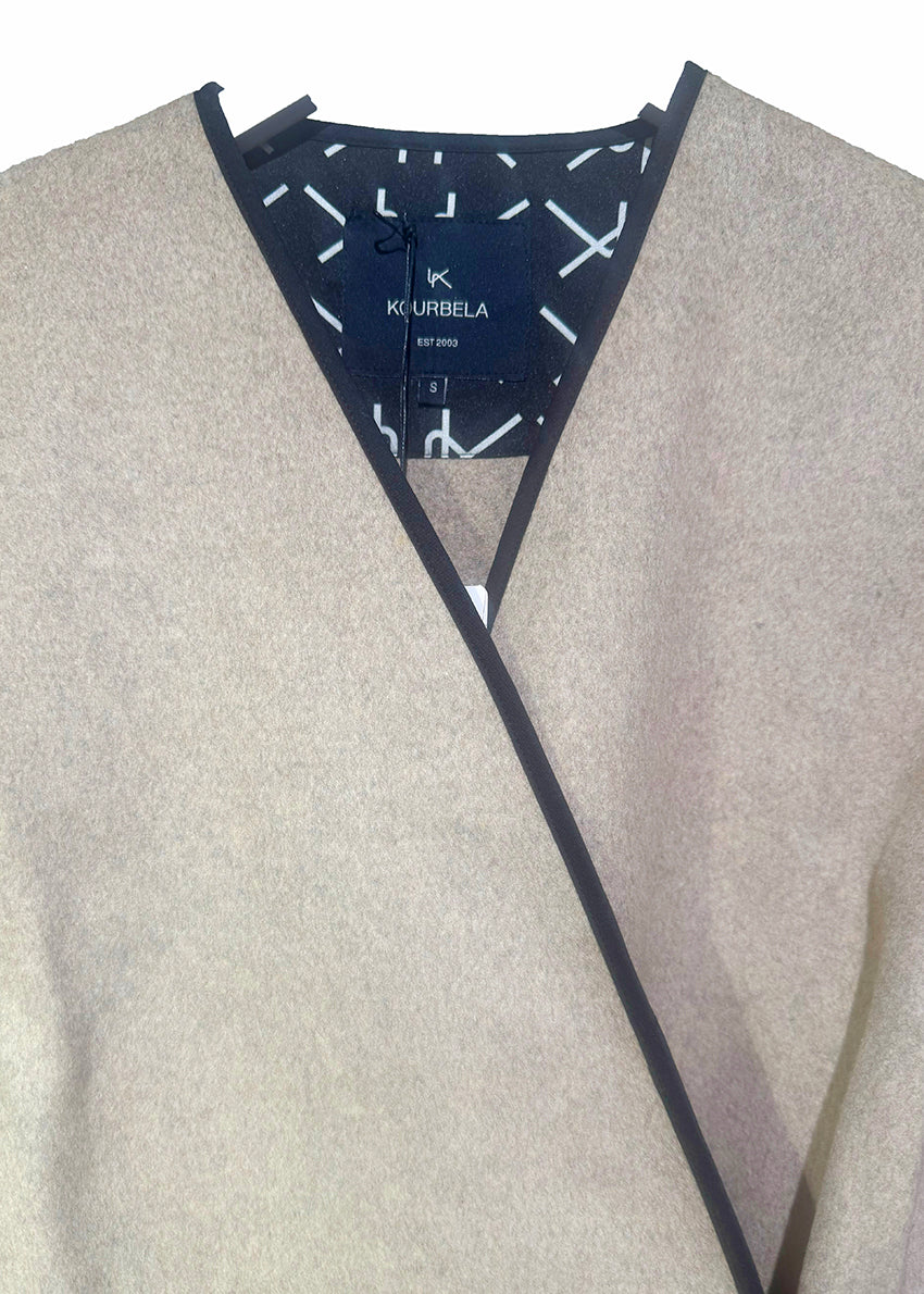 Short wrap beige coat made of furry wool that ties at the side and has a detachable scarf.A winter must – have coat that can be worn from morning to night.