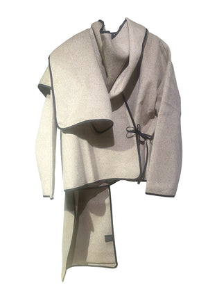 Short wrap beige coat made of furry wool that ties at the side and has a detachable scarf.A winter must – have coat that can be worn from morning to night.