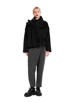 Short wrap black coat made of furry wool that ties at the side and has a detachable scarf.A winter must – have coat that can be worn from morning to night.