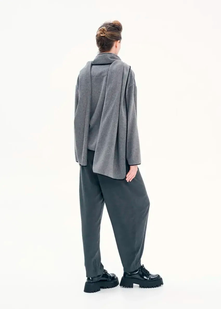 Short wrap grey coat made of furry wool that ties at the side and has a detachable scarf.A winter must – have coat that can be worn from morning to night.