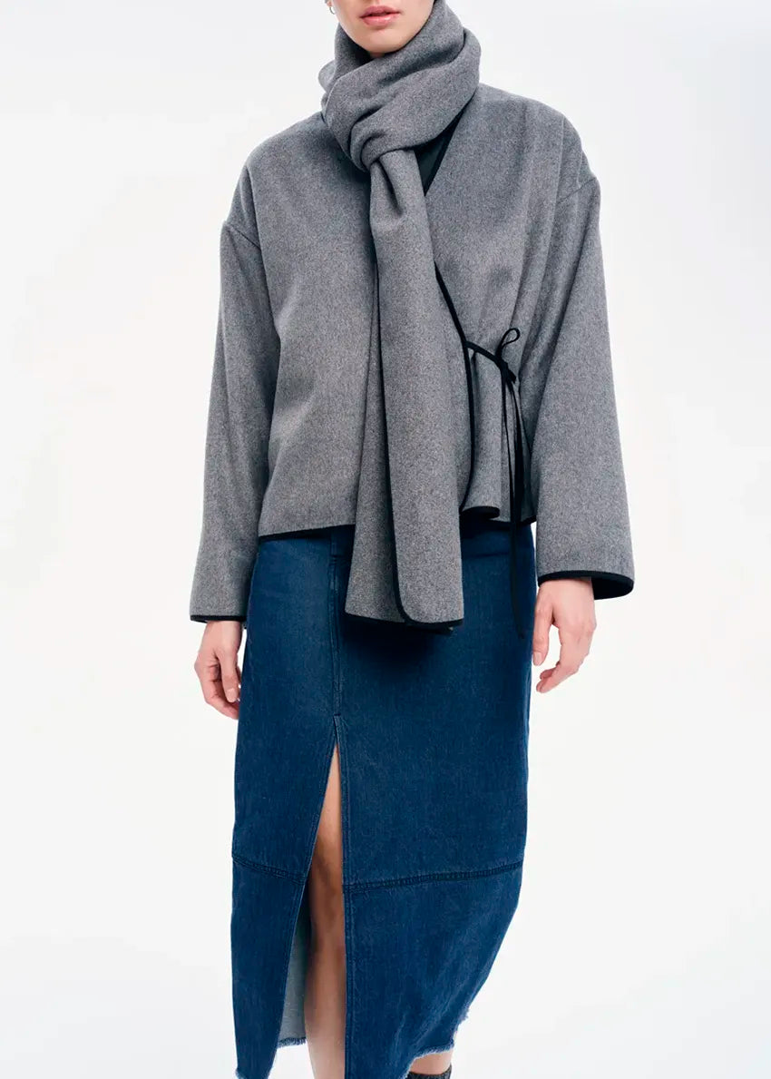 Short wrap grey coat made of furry wool that ties at the side and has a detachable scarf.A winter must – have coat that can be worn from morning to night.