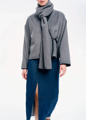 Short wrap grey coat made of furry wool that ties at the side and has a detachable scarf.A winter must – have coat that can be worn from morning to night.