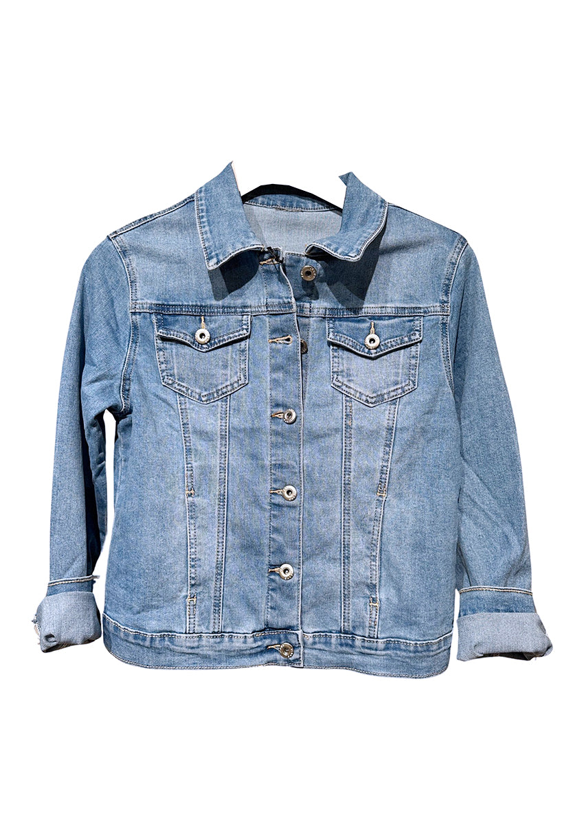 A person wearing a classic trucker jacket with a spread collar, front button closure, and chest button-flap pockets, seated with a pile of orange beads in their hand.