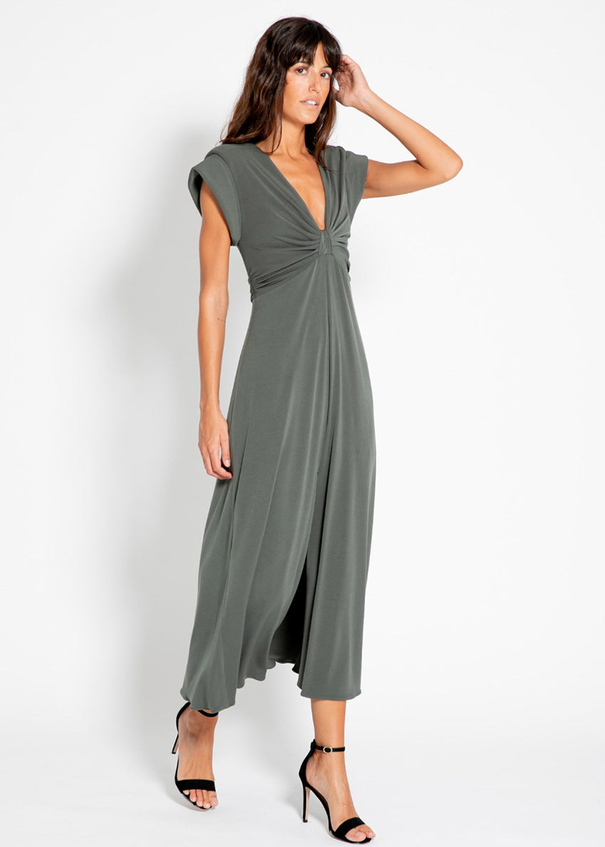 The long knotted grey dress with a V-neckline is a sophisticated and stylish garment. The dress features a knotted detail at the waist