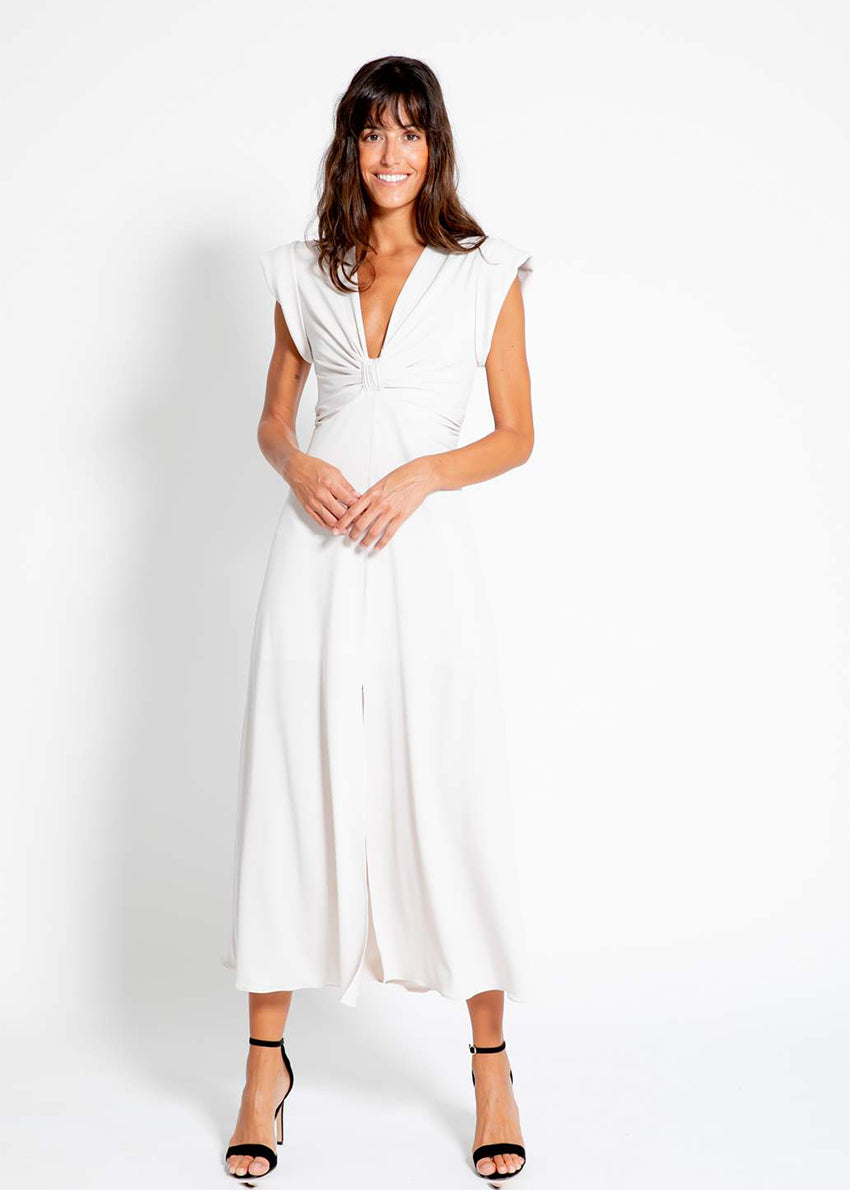 The long knotted green dress with a V-neckline is a sophisticated and stylish garment. The dress features a knotted detail at the waist