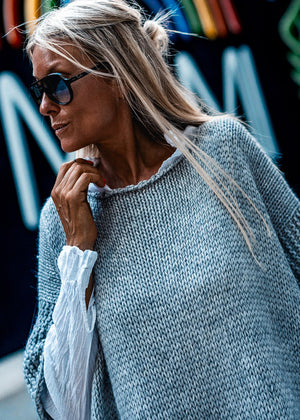 Woman wearing a grey poncho
