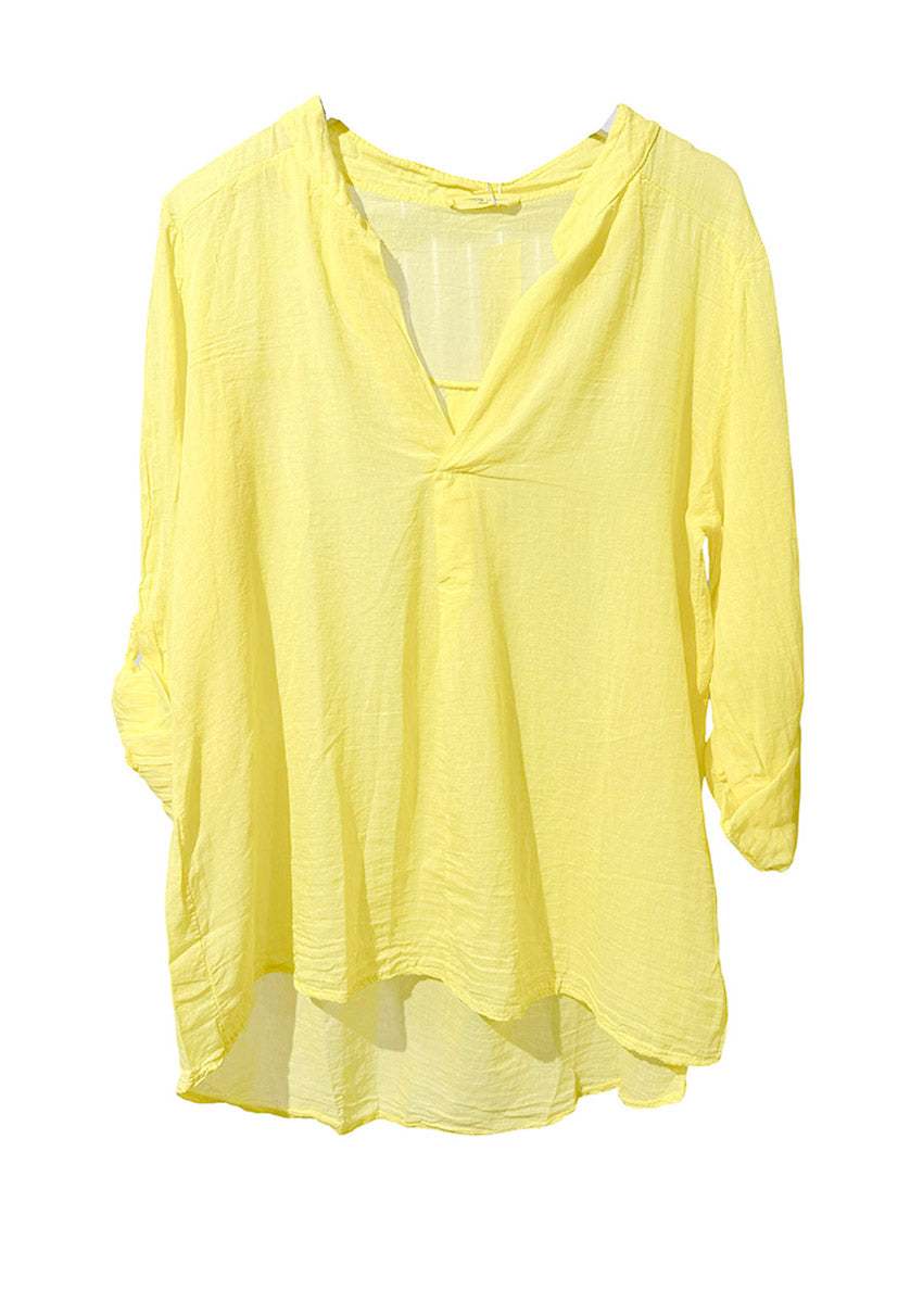Yellow shirt with a V-neck and long sleeves on a white background