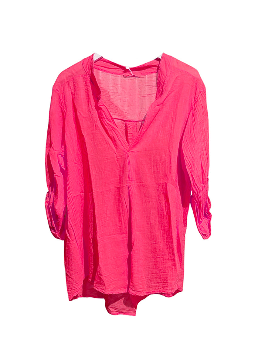 A deep pink shirt on a white background 