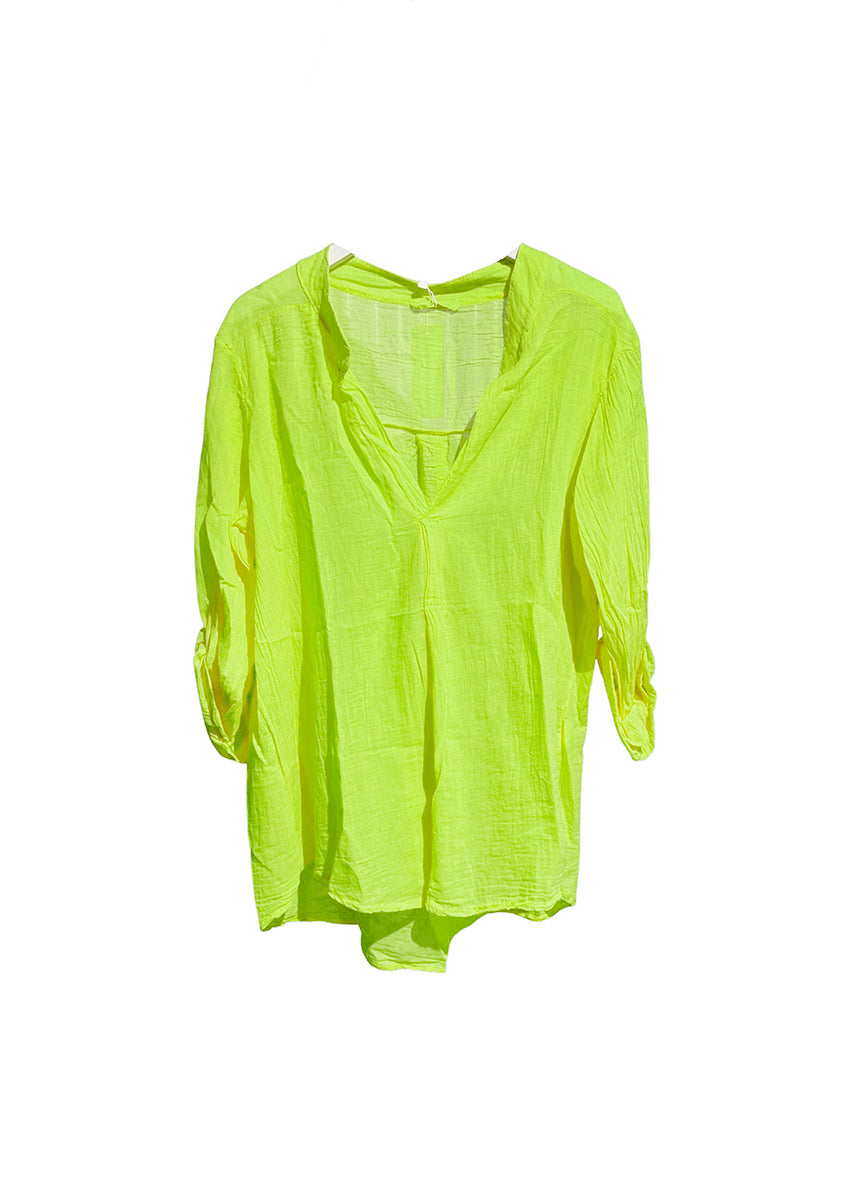 A yellow green shirt on a white background 