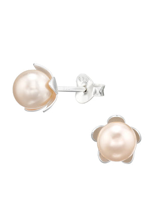 A pair of silver earrings with rose-colored flower-shaped pearls, against a white background.