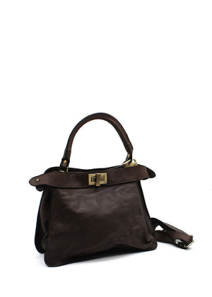 A leather handbag with a structured shape, featuring a top handle, a detachable shoulder strap, and a gilded closure.