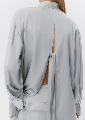 Light gray blouse with open back on a white background