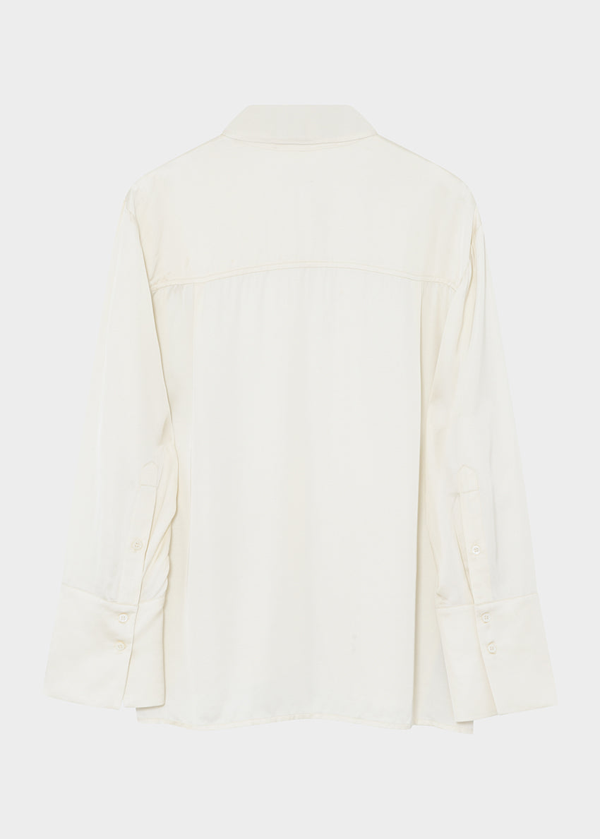 White blouse with a V-neckline on a light gray background