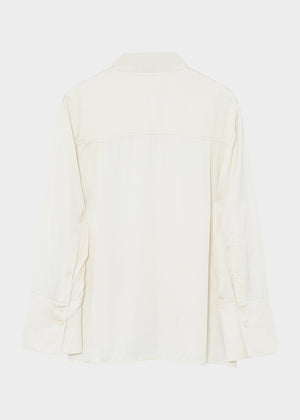 White blouse with a V-neckline on a light gray background