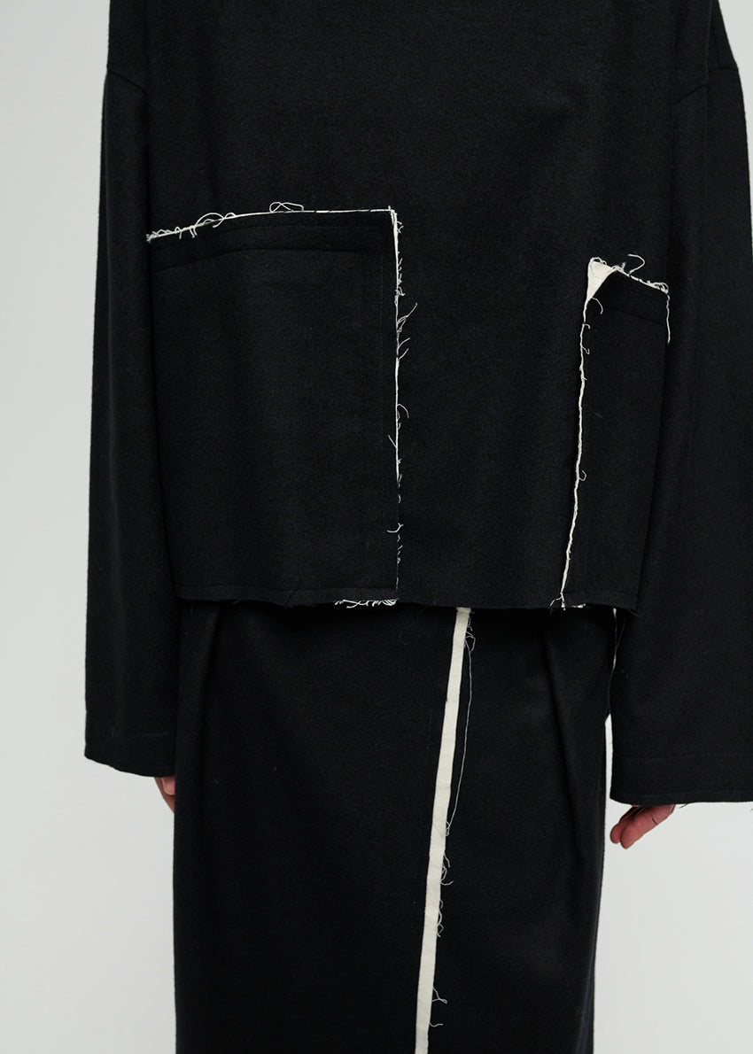 Black outfit with white stitching on a plain background