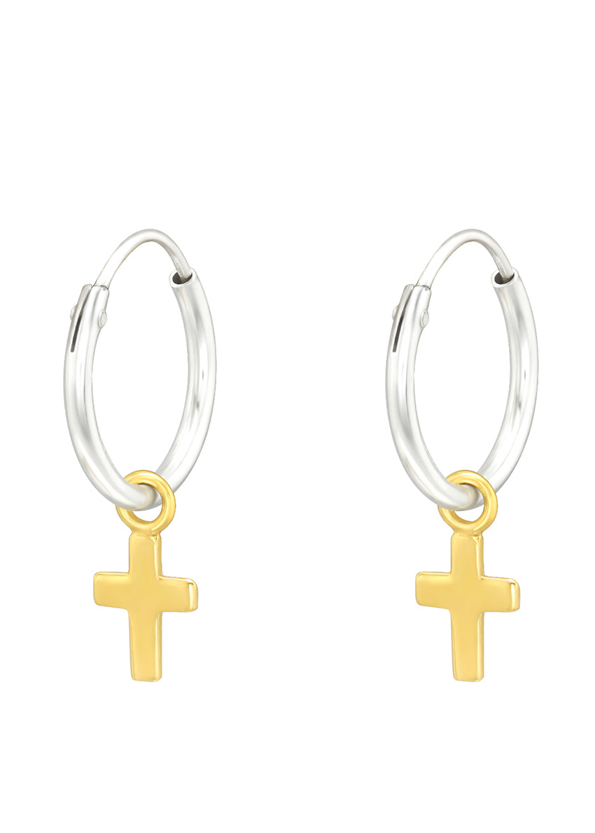 A pair of round silver earrings with a golden cross at the center, against a white background.