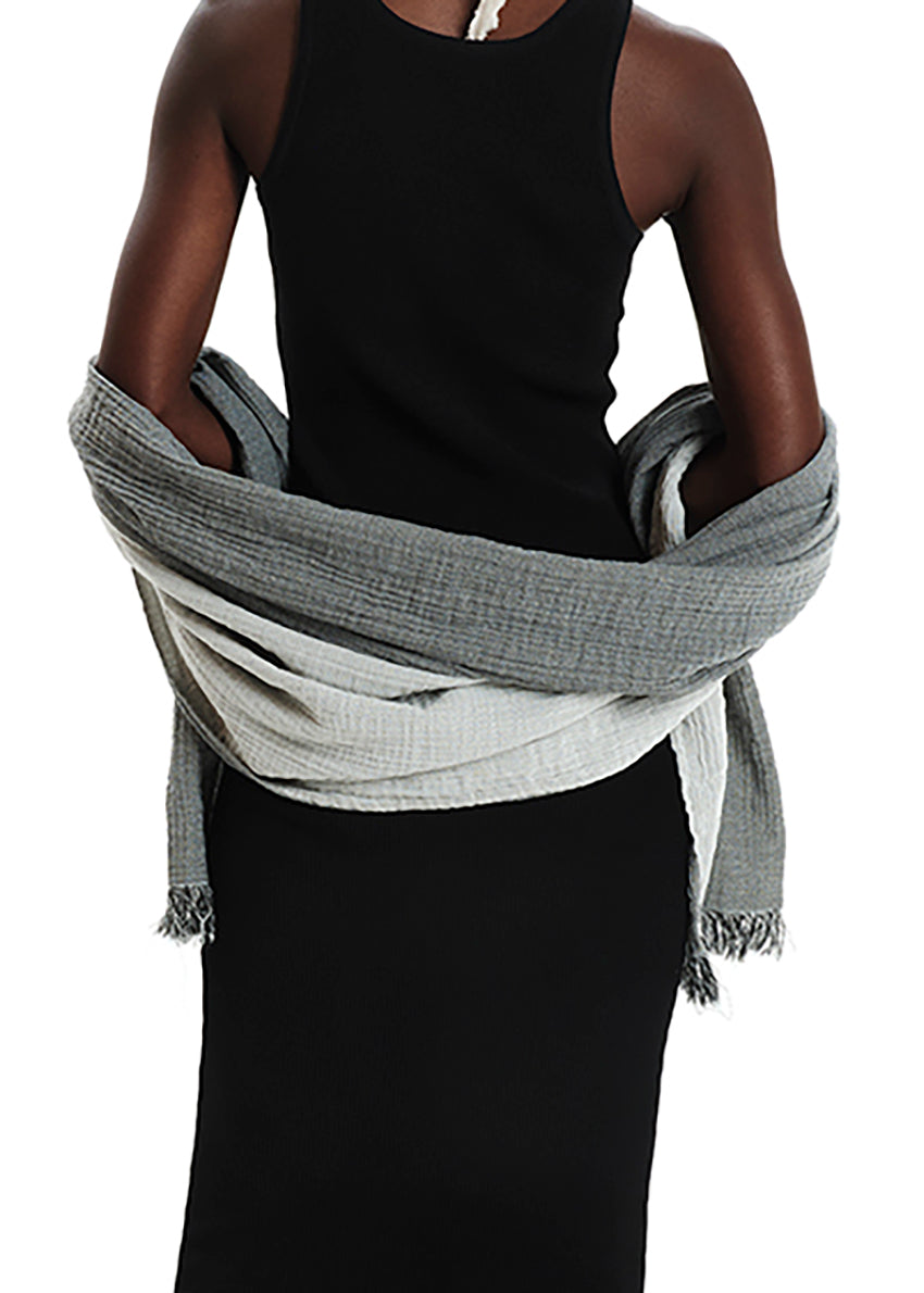 Person wearing a gray scarf with a white background