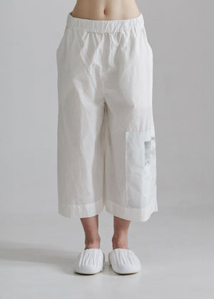 White wide-leg pants worn by a person on a plain background