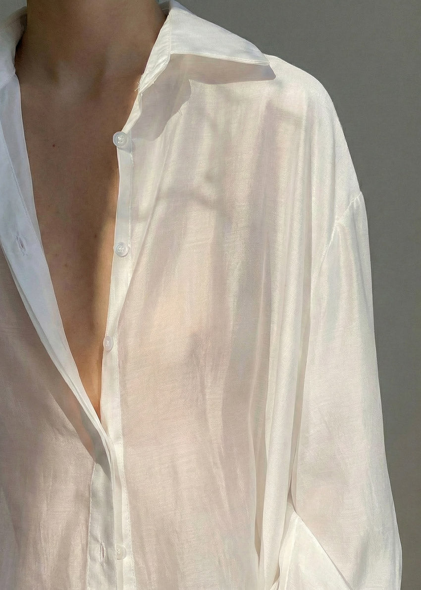 White shirt with a deep neckline on a neutral background