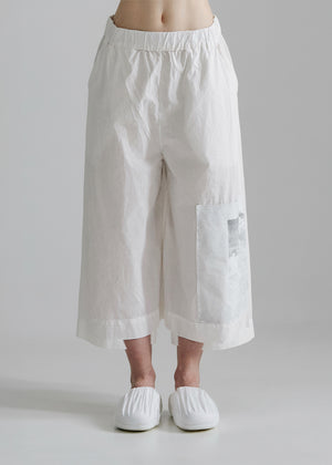White wide-leg pants worn by a person on a plain background