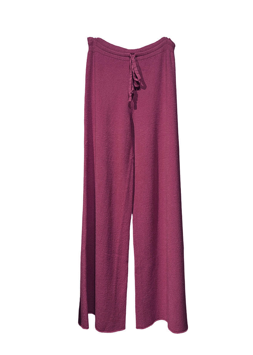 Long wide dark red pants made of a soft viscose blend, they feature elastic drawstring, perfect for resort lifestyle, travel comfort and fireplace parties