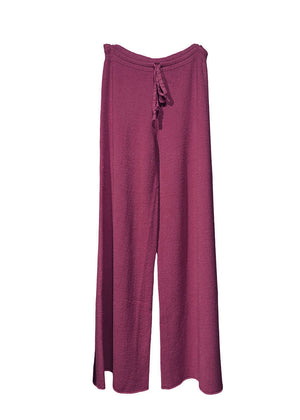 Long wide dark red pants made of a soft viscose blend, they feature elastic drawstring, perfect for resort lifestyle, travel comfort and fireplace parties