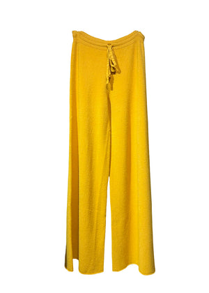 Long wide yellow pants made of a soft viscose blend, they feature elastic drawstring, perfect for resort lifestyle, travel comfort and fireplace parties