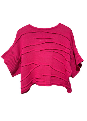 Pink layered knit poncho on a white background