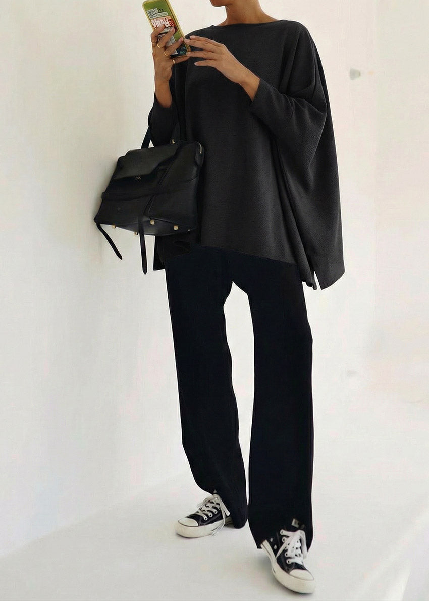 Person wearing a black outfit with a backpack on a white background