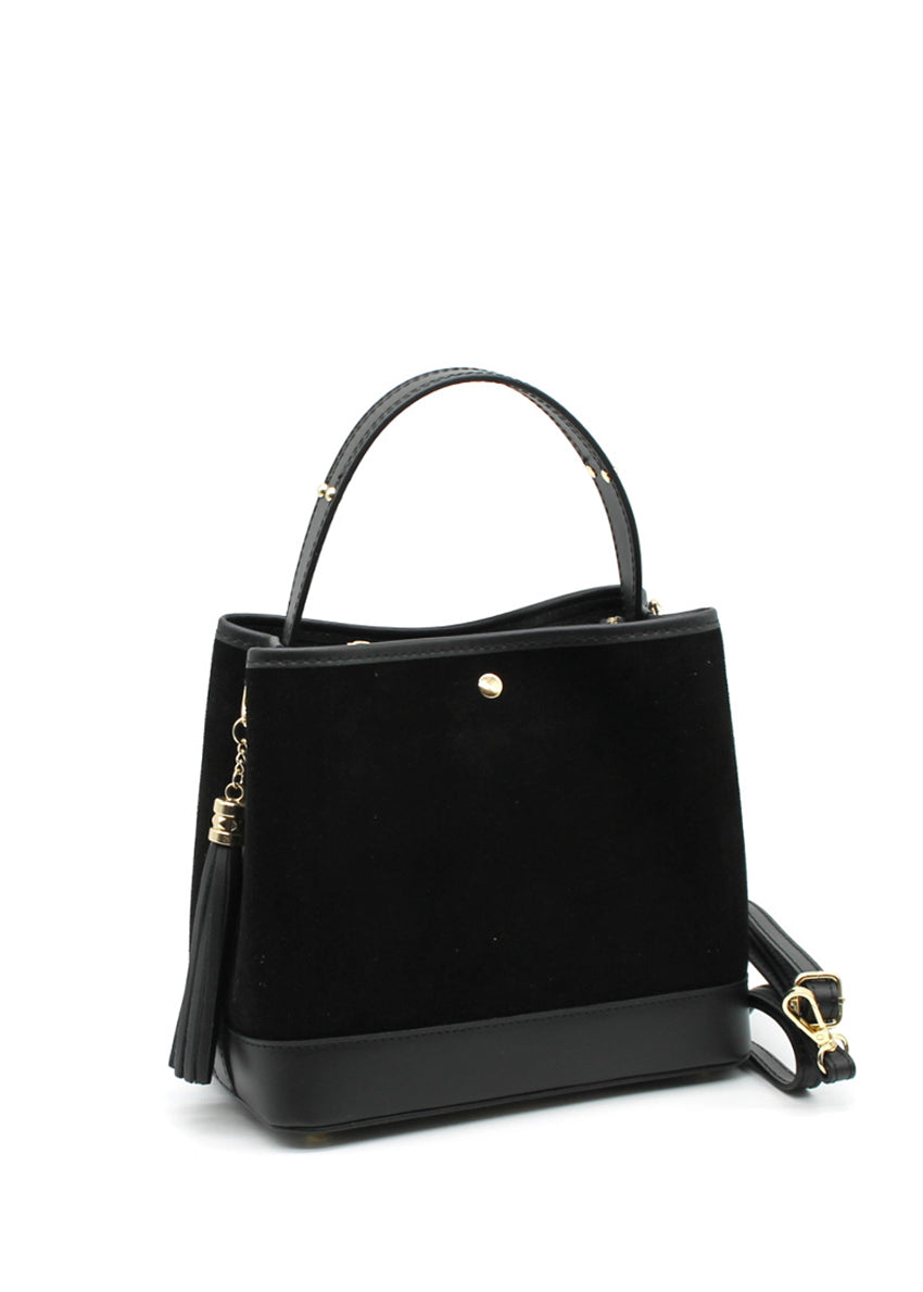 A black suede and leather handbag with a circular handle, fringe accents, and a crossbody strap.