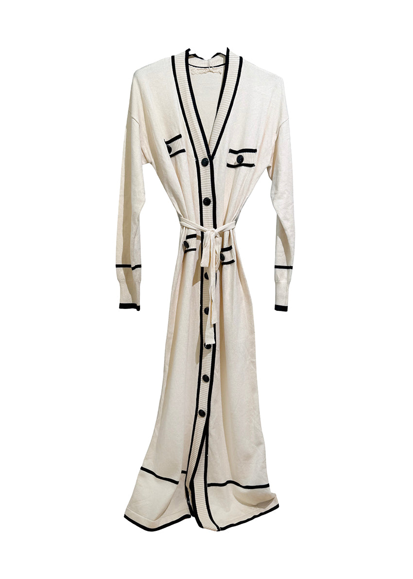 White dress cardigan with black accents on a white background