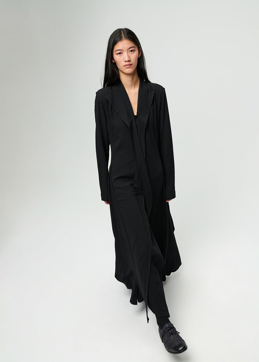 Person wearing a black dress on a white background