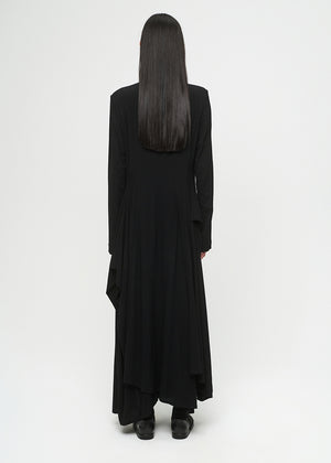 Person wearing a long black dress on a white background