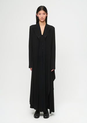 Model wearing a long black dress on a white background